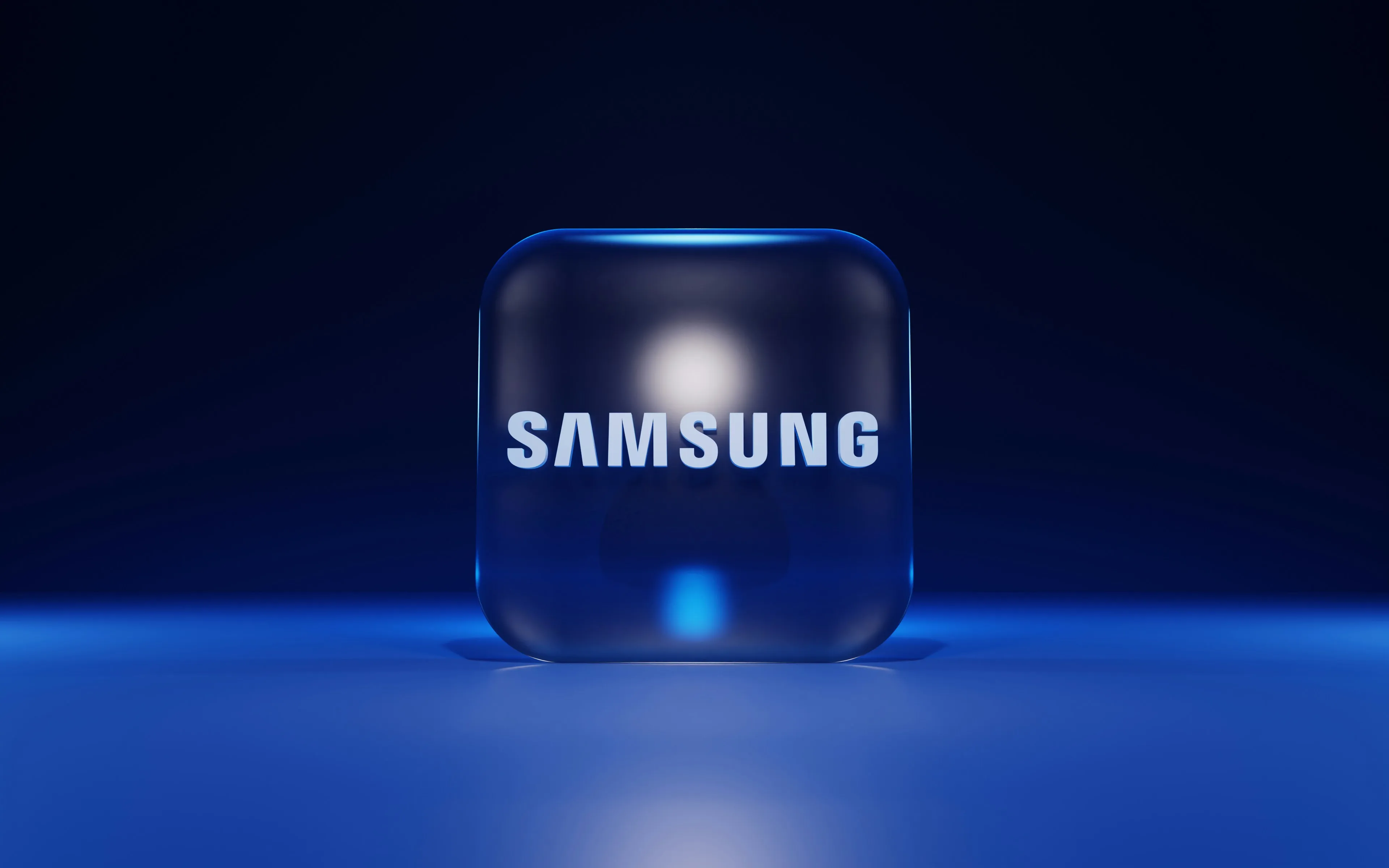 Samsung wordmark displayed on a glossy blue cube against a dark blue background