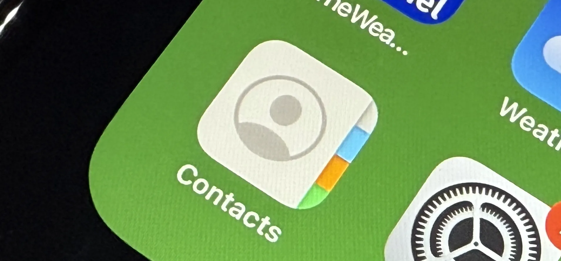 The Contacts app icon on the iPhone's Home Screen.