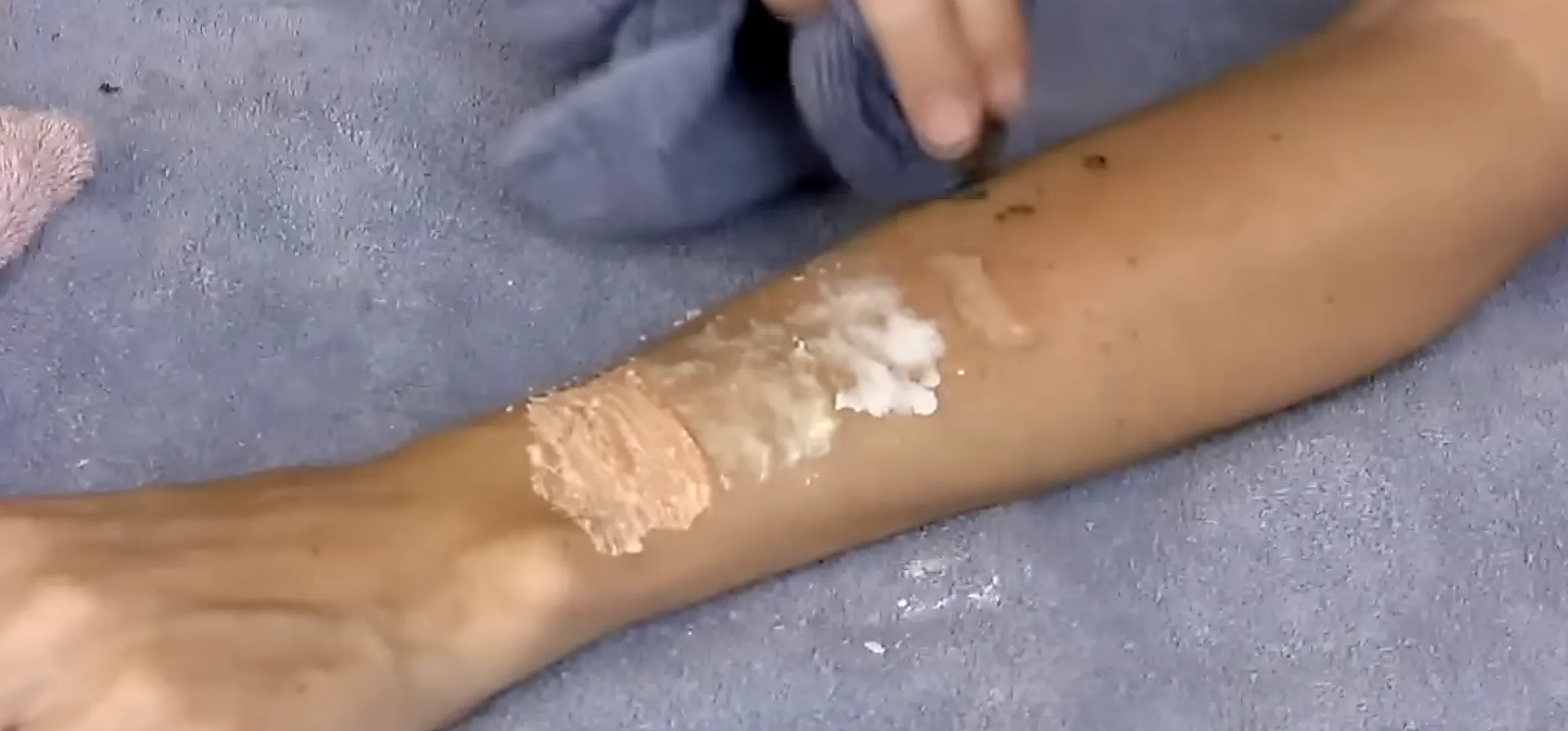 Different colored creams spread across someone's forearm.