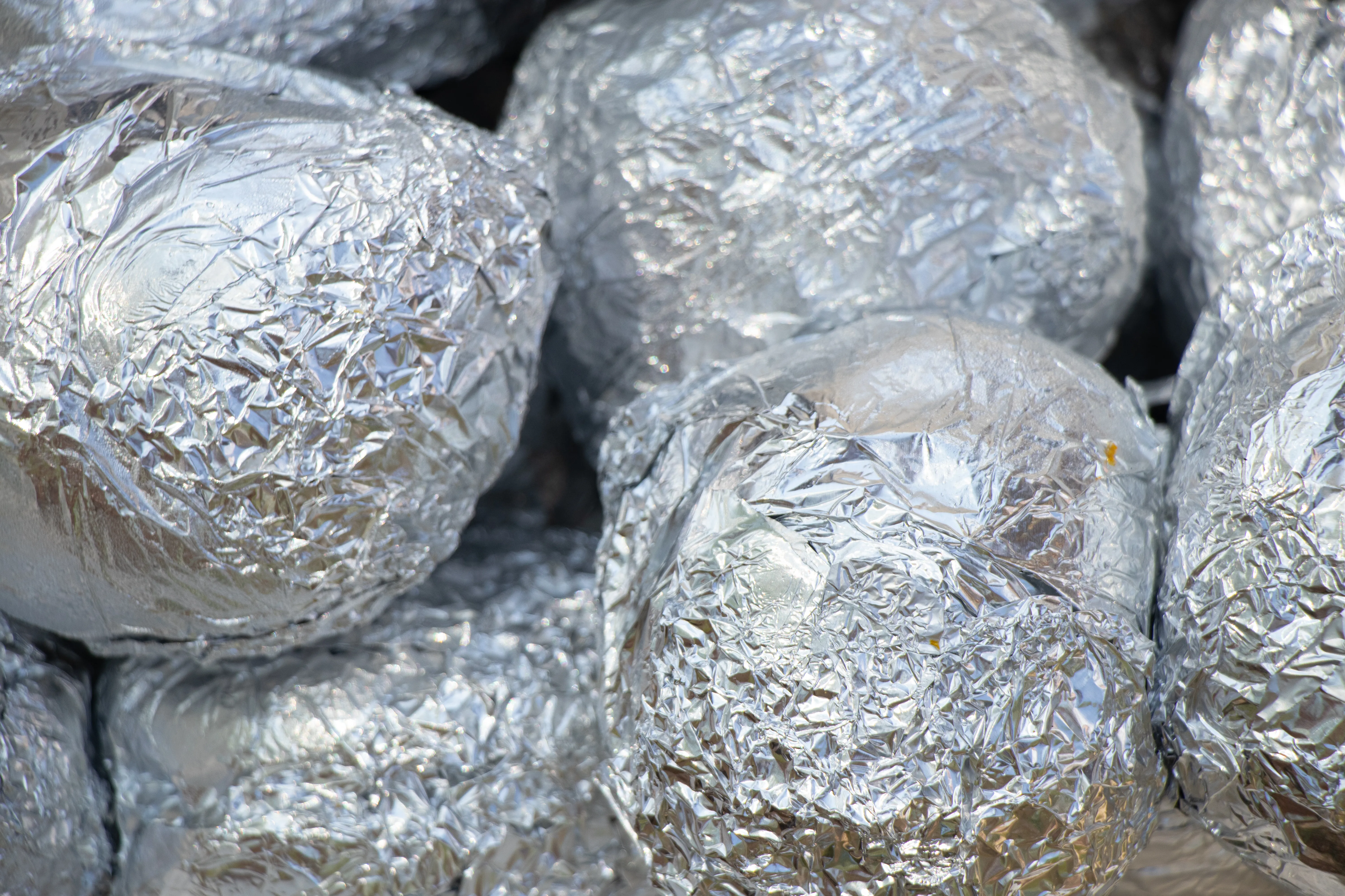 Closeup of a bunch of shiny aluminum foil balls.