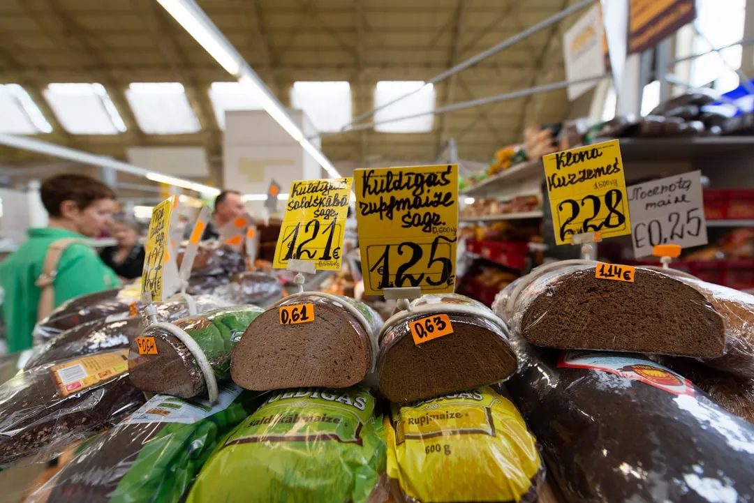 A hand holding a bottle labeled "Cheap Red Wine."