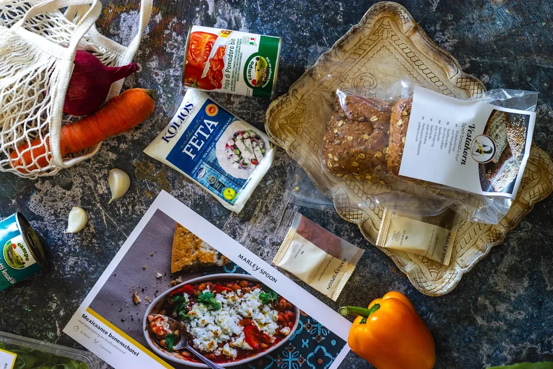 Colorful sushi rolls arranged on a wooden plate on top of a striped green and yellow tea towel.