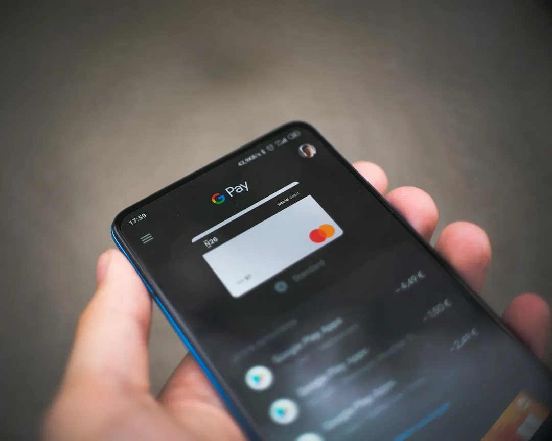 Smartphone with various app icons on the screen.
