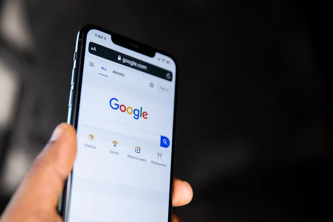Smartphone with various app icons on the screen.