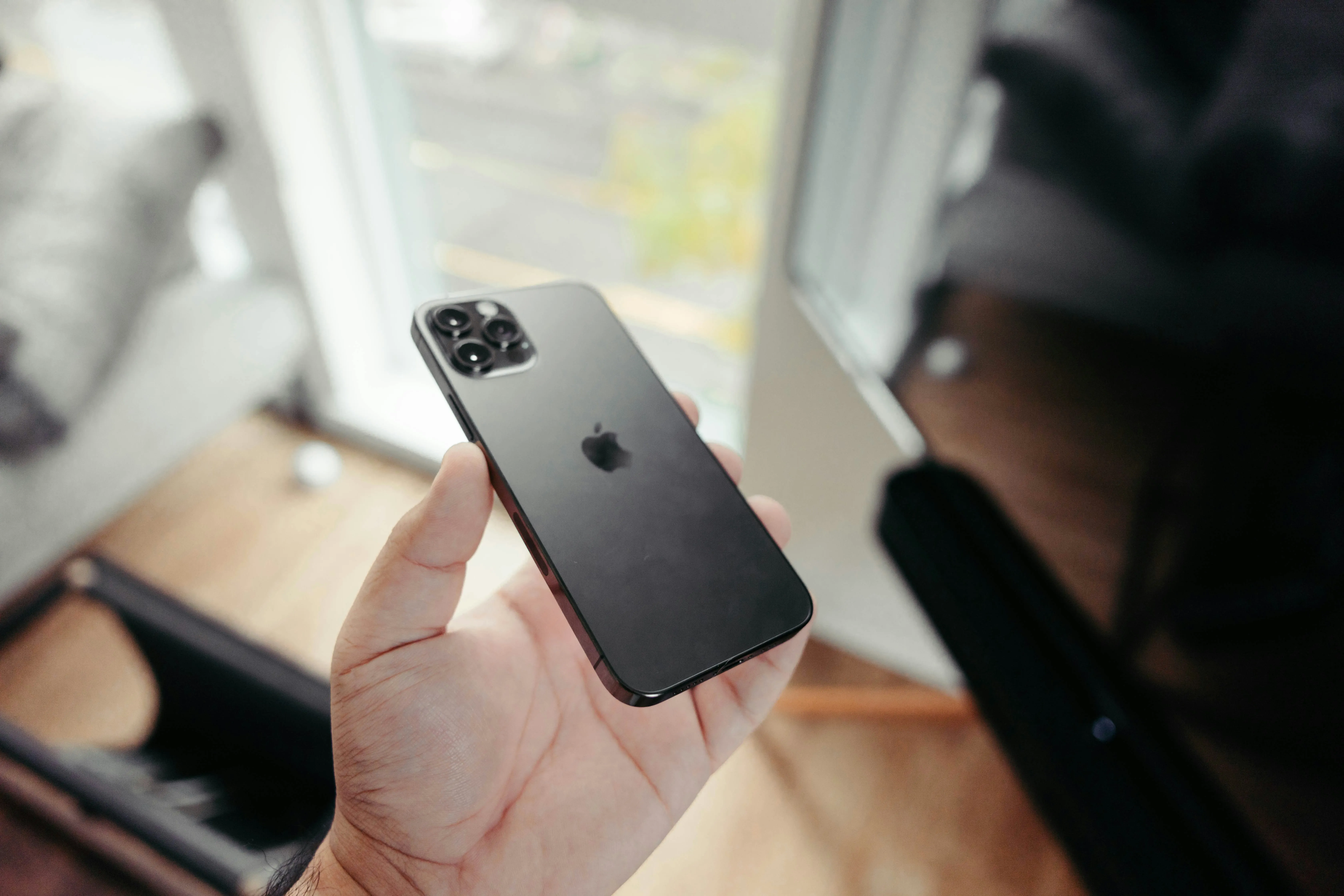 Smartphones with Apple logo on a dark background.