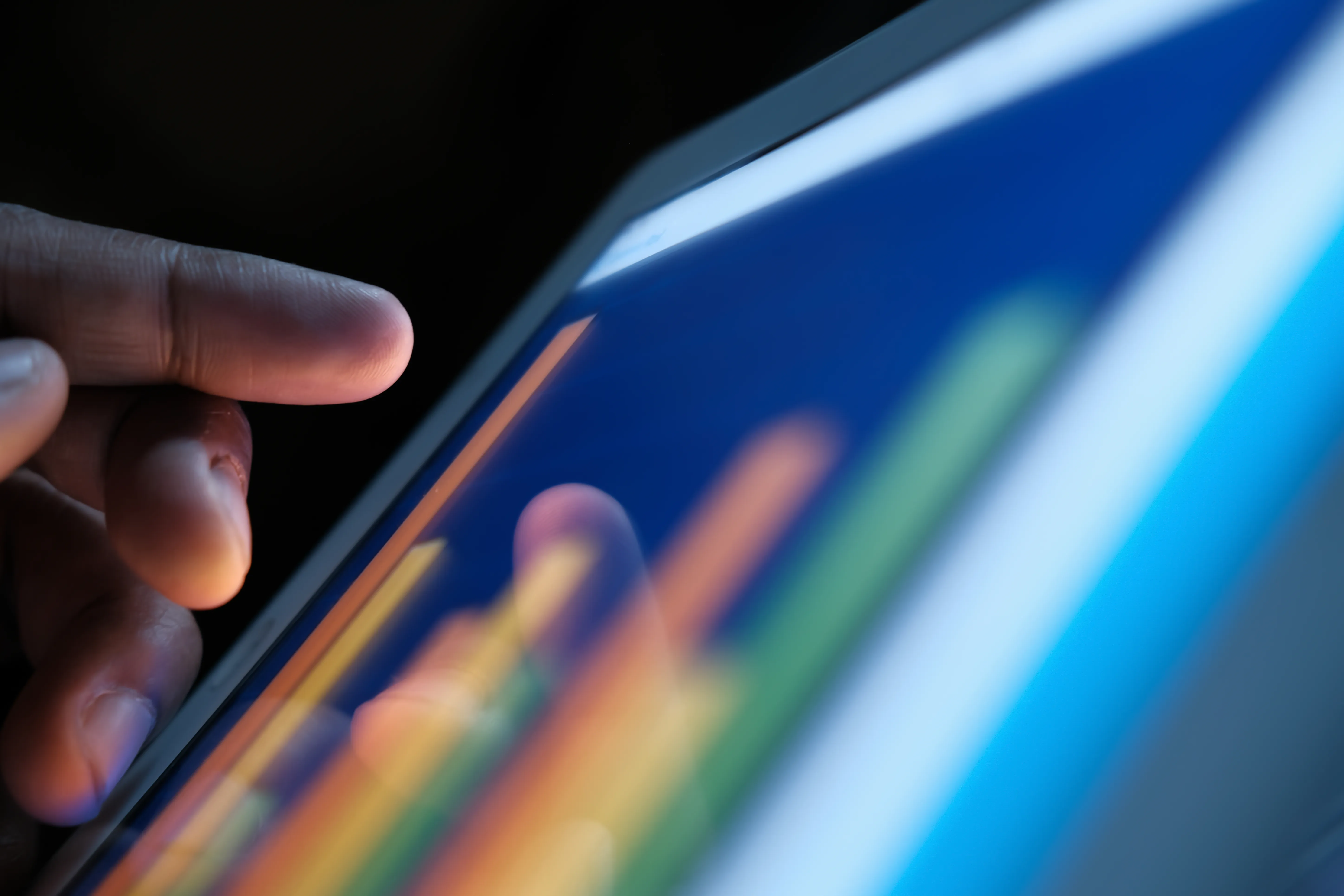 image of a hand interacting with a tablet