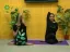 Yoga practitioners demonstrating flexibility poses with plants in a professional setting.