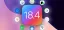 A simulated iOS 18.4 logo with some of the new features appearing around it.