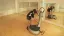Man using a vibration plate machine in a gym.