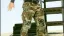 Person wearing camouflage pants in a military training environment.