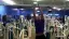 Man performing a pull-up in a gym.