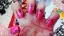 Bright pink nail art with black floral designs.