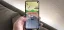 Person playing a racing game on a smartphone, showing the "FINISH" screen.