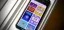 Smartphone displaying various game applications on screen.