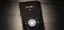 Smartphone displaying the time 11:34 PM on a wooden surface.