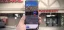 A person holding a smartphone displaying an augmented reality view of a pharmacy storefront.