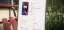Smartphone specifications displayed on a screen outdoors.