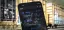 Mobile phone displaying a map application with a blurred industrial background.