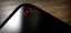 Smartphone camera lens with a red indicator light.