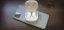 Wireless earbuds in charging case on top of a smartphone.