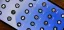 Smartphone screen displaying various app icons on a blue background.