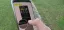 A person using a smartphone to view social media content outdoors.