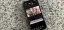 Smartphone displaying a video editing application on a granite surface.