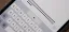 Close-up of a smartphone keyboard with text entry field showing the Apple logo multiple times.