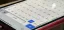 Closeup of an iPhone smartphone screen showing the iOS keyboard's top-level domains available in a pop-up with dozens of international domain extensions.