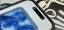Close-up of a smartphone screen displaying a blue abstract image.